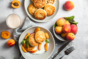 Cottage cheese pancakes with sour cream and apricots