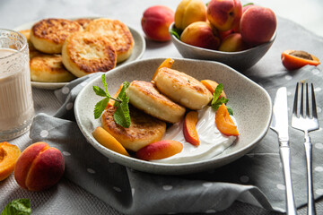 Cottage cheese pancakes with sour cream and apricots