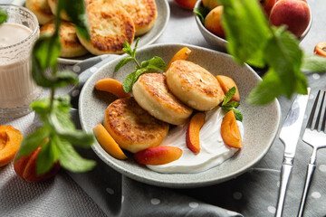 Cottage cheese pancakes with sour cream and apricots