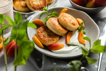 Cottage cheese pancakes with sour cream and apricots