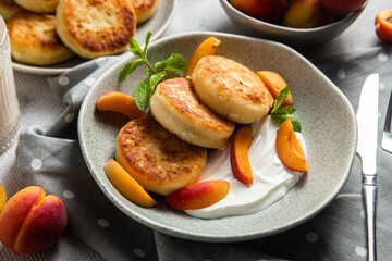 Cottage cheese pancakes with sour cream and apricots