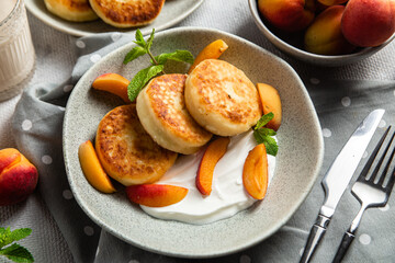Cottage cheese pancakes with sour cream and apricots