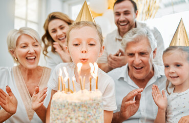 Big family, girl and birthday cake in home for blow, celebration or express gratitude with hands. People, grandparents or parents with kids for daughter party, growth or new age with dessert on table