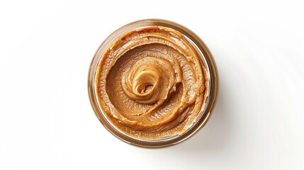 A jar of creamy peanut butter sitting on a clean white background