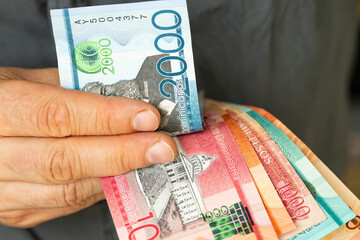 Dominican Republic money, Man converts Dominican pesos, Cash in hand, Financial business concept
