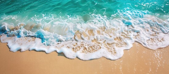 Fototapeta premium Tranquil beach setting with soft waves lapping against sandy coastline. Azure crystal-clear ocean, golden sands. Ample room for advertising summer getaways.