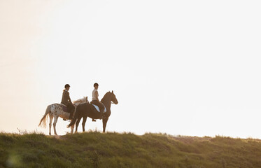 Fototapeta premium Horse riding, friends and people in countryside in nature on vacation, holiday or travel on mockup space. Equestrian, animals or women on horseback in field on adventure, journey or together on grass