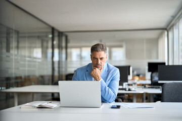 Busy serious middle aged professional business man financial investor, 50 year old senior...