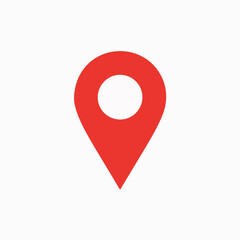 A red location pin icon. The pin is designed with a rounded top, resembling a location marker, and a pointed bottom, indicating direction. It is set against a white background