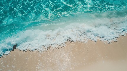 Crystal clear turquoise waves gently lapping against a pristine white sandy beach.