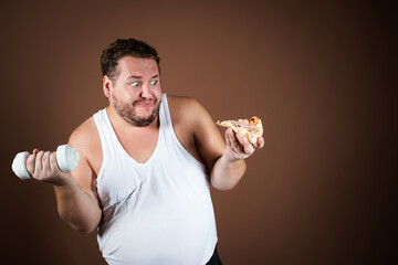 Funny fat man on a diet eating pizza. Brown background.