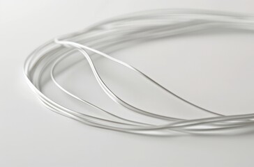 Silver Wire Spool on a White Surface