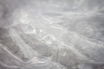 Extreme macro of plastic bubble wrap texture. Selective soft focus, shallow depth of field. Abstract dreamy background