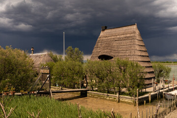 Casoni in the sun against dark clouds at the horizon