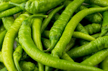 Hot green pepper in pods. Close, background, horizontal.