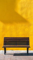 Bench next to yellow wall