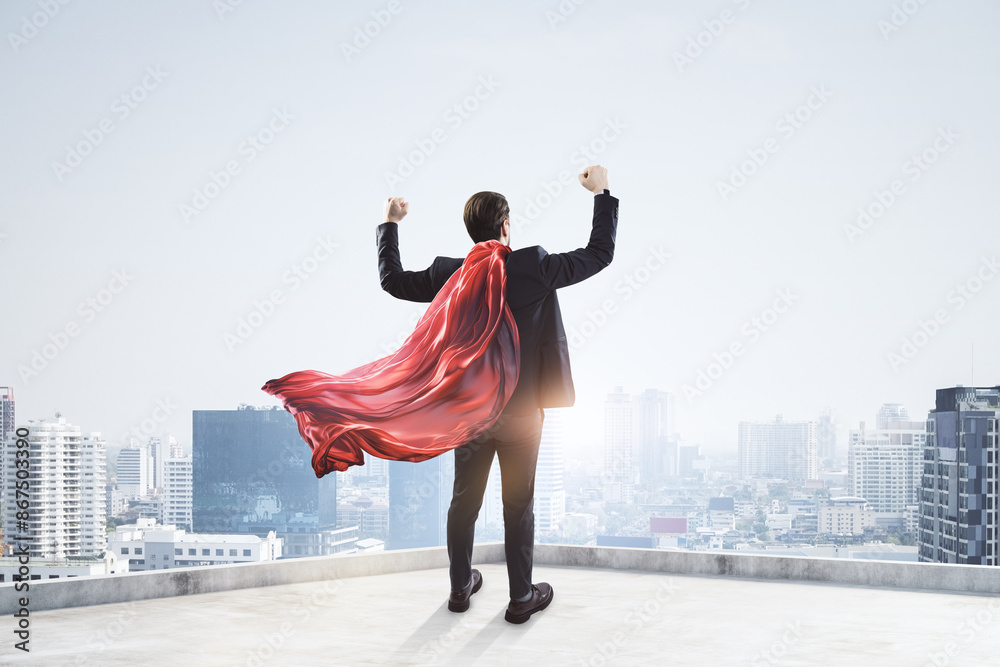 Poster man in a suit with a red cape posing heroically on a rooftop, cityscape background, concept of succe
