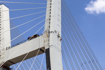 Obraz premium Novosibirsk, Novosibirsk region, Russian Federation - June 01 2024. Workers on a cable-stayed bridge