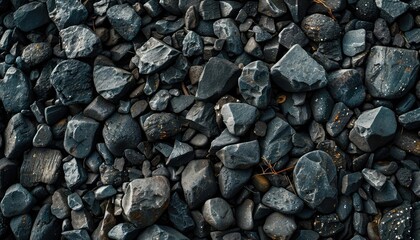 Black pebble stone background with scattered, small stones creating an organic texture
