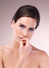 Portrait, woman and skincare with cosmetics, beauty and wellness for dermatology in studio backdrop. Female person, healthy skin and cosmetology in blue background for hydration, collagen and glow