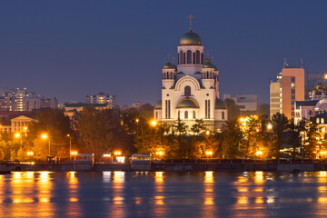 The city of Yekaterinburg, Sverdlovsk region, Russia. View from the Iset river to the Church of All Saints. Evening cityscape with a beautiful large Orthodox church.