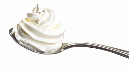 Whipped cream nicely curled on a spoon isolated on white background. Nitrous oxide fuels the expulsion of whipped cream from spray cans, which was recently in short supply due to a factory explosion.