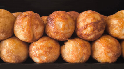 Takoyaki snacks on a black tray, Japanese style food