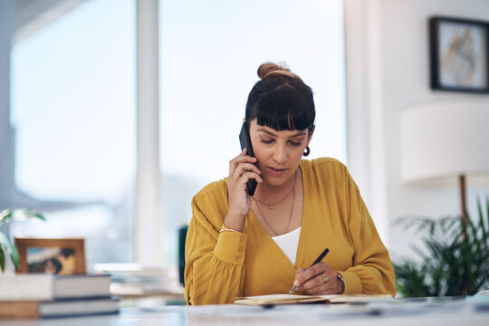 Business woman, writing and phone call with documents for query, question or reminder on financial payments at office. Young female person taking notes or settling debt with book on mobile smartphone