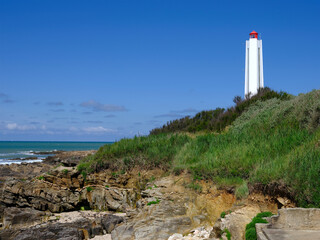 Armandeche lighthouse on rocky coast at Les Sables d’Olonne, commune in the Vendee department in the Pays de la Loire region in western France