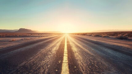 Naklejka premium Desert Highway at Sunrise: Empty Road Leading to the Horizon