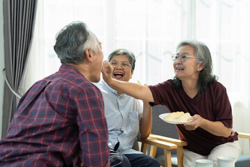 Happy Senior friends group meet and spend leisure time with happy in living room