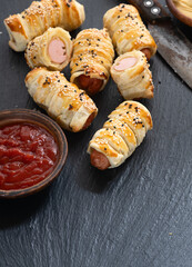 Homemade Sausage in dough rolls on plate