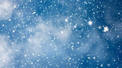 Fototapeta premium Snowy Sky: Soft White Snowflakes Against a Blue Sky Background