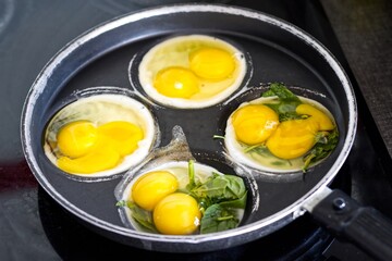 Four double yolk eggs baked in a pan, healthy fresh natural eggs for breakfast.