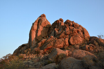 Fototapeta premium Stone peak on the hill against the background of the blue sky. Tourist destinations and nature