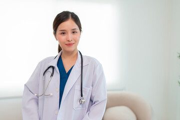 Fototapeta premium Portrait of Mature Female Doctor Wearing white Coat with Stethoscope Standing in Hospital Corridor. Concept Of Medical Technology and Healthcare Business.