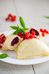 steamed sweet homemade dumplings with berries, red currants
