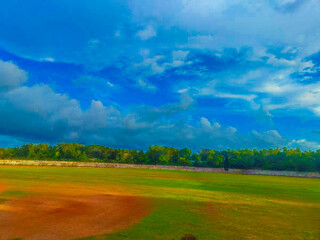 field and sky with clouds