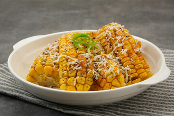 Spicy corn ribs with barbecue sauce and grated cheese
