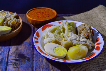 Siomay are steamed fish and vegetable dumplings served with peanut sauce.  Traditionally made from mackerel fish.  Siomay is a typical Bandung city food.