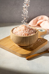 Himalayan pink salt, raw crystals in wooden bowl