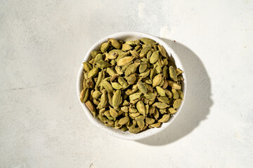Closeup green cardamom spice on bright background
