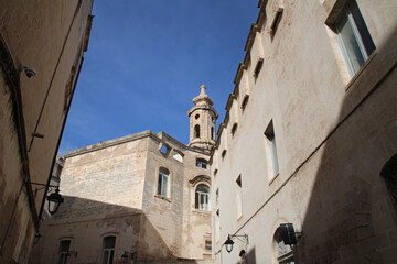 Old building with tower in the city centre of Monopoli, Italy. 