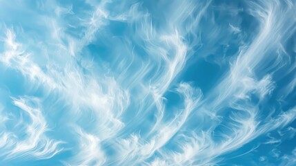 Obraz premium Abstract background of wind shaped soft white clouds against a blue sky