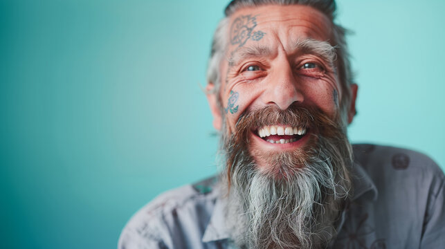 Close up portrait of happy elderly optimist man with tattoo face. Modern Aging.