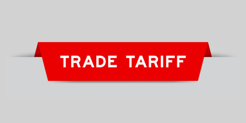 Red color inserted label with word trade tariff on gray background