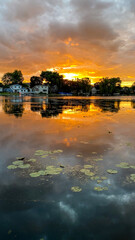 Dramatic Orange Sunset over Yarhara River Channel with Water Reflections