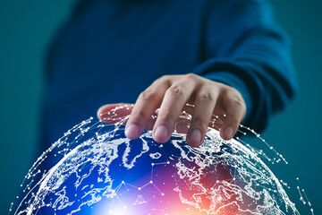 A person touching a glowing digital globe with network connections on a blue background, symbolizing global communication and technology.
