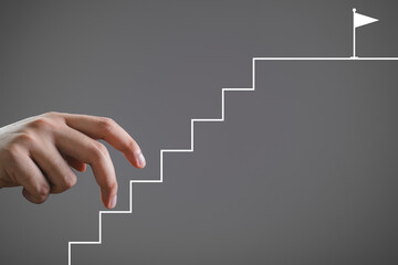 Hand mimicking walking up drawn stairs towards a flag, symbolizing steps towards achievement, goal...