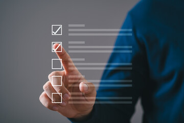 Person tapping virtual checklist on transparent screen, symbolizing tasks, productivity, and...